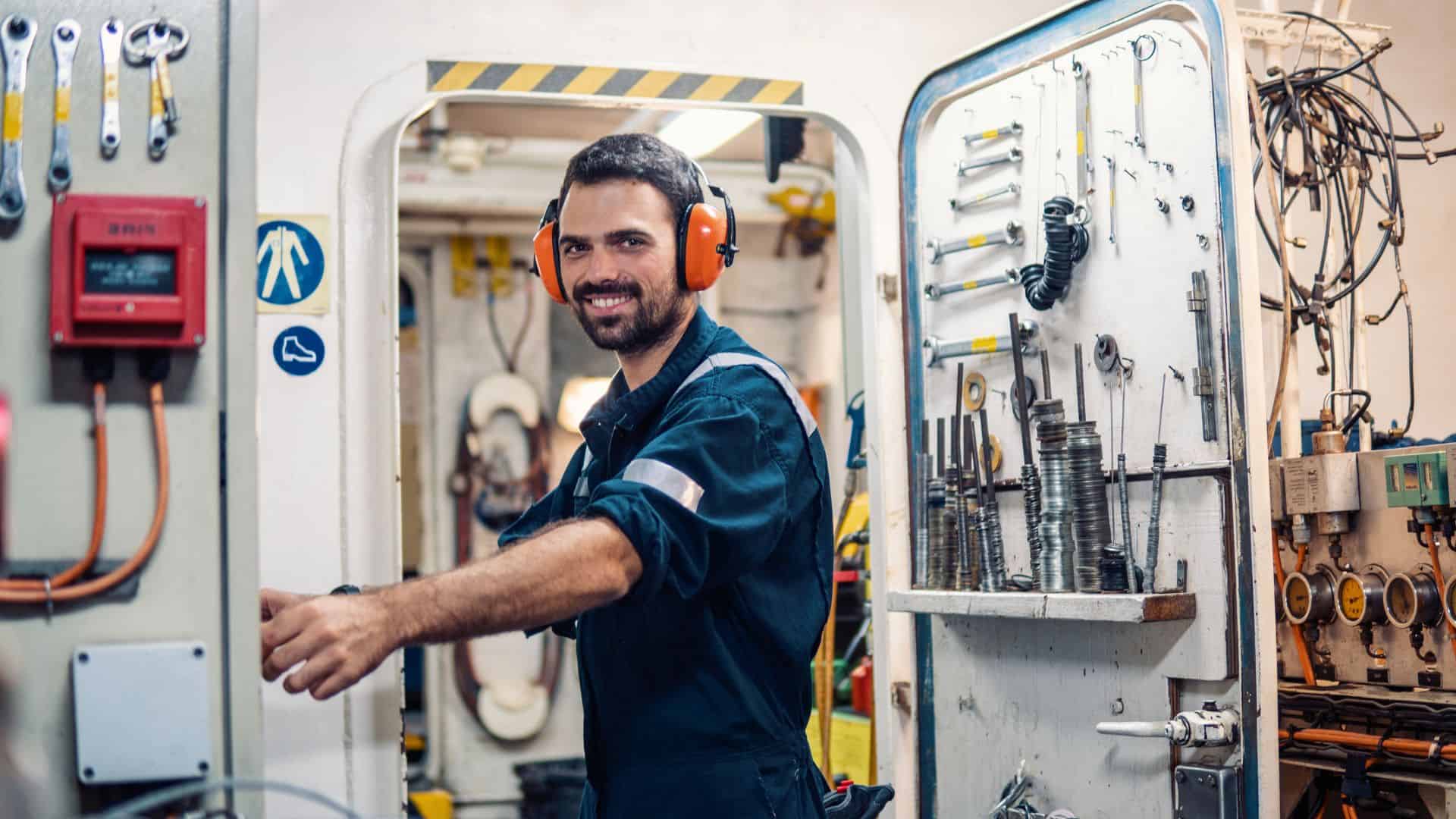 Melbridge engineer working in a ship's technical room.