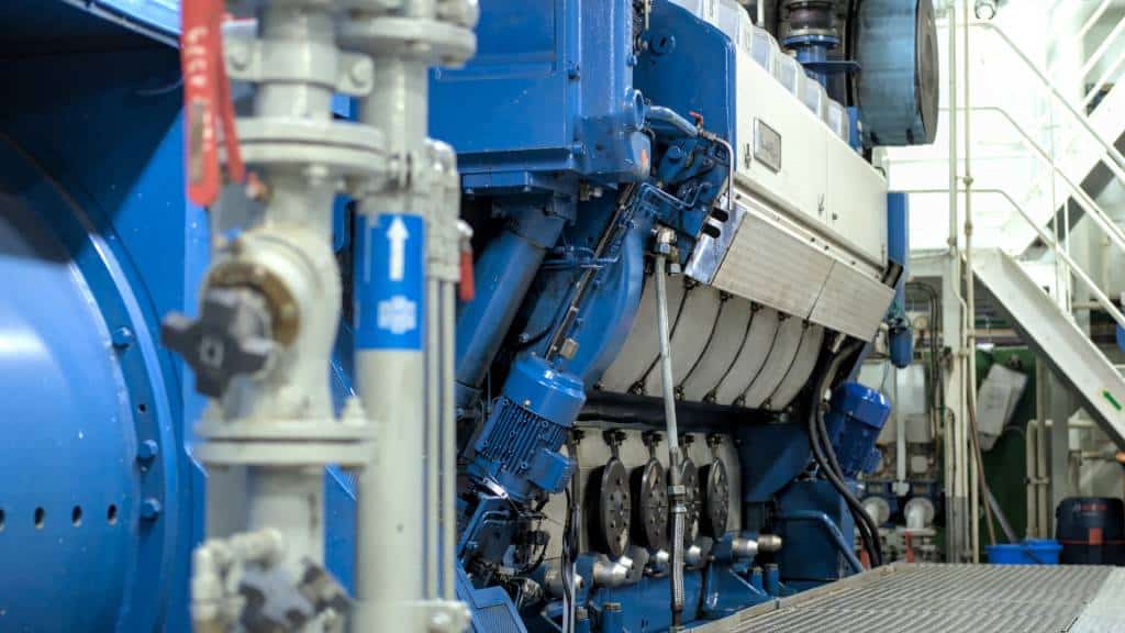 Close-up of marine engine components and piping system.