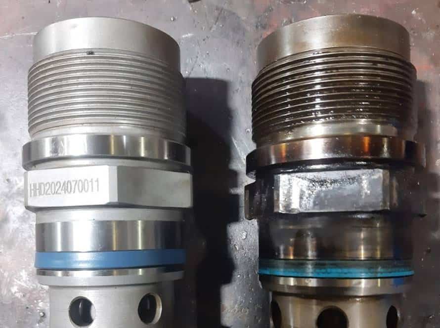 Two large engine components on a workshop surface.