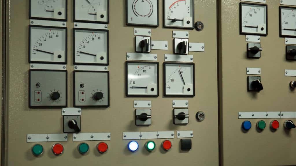 Close-up of an electrical control panel with gauges and switches.
